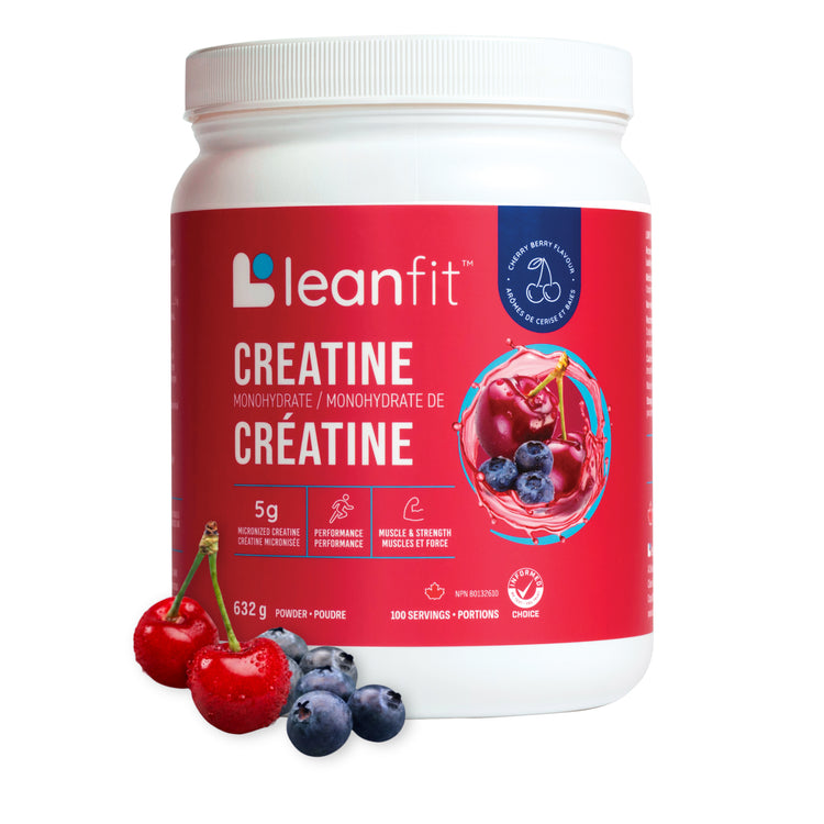 A white plastic tub of leanfit Creatine powder with a red label, shown on a white background with fresh cherries and blueberries in front of the container.