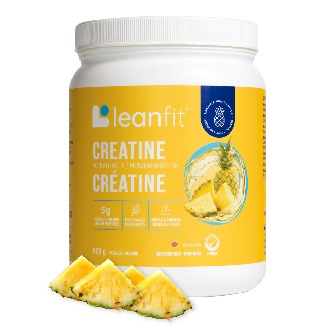 A white plastic tub of leanfit Creatine in pineapple flavor, shown on a white background with several pineapple slices in front of the label.