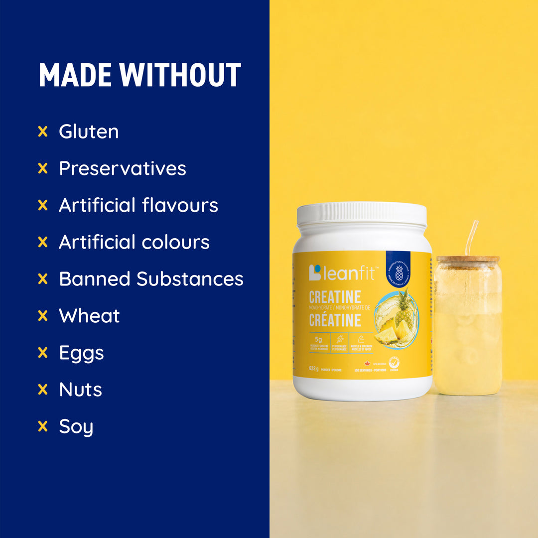 A white tub of leanfit Creatine with a yellow label stands next to a glass of pale yellow drink on a yellow surface against a yellow background. A dark blue text panel on the left reads 'MADE WITHOUT' with a list of allergens and ingredients.