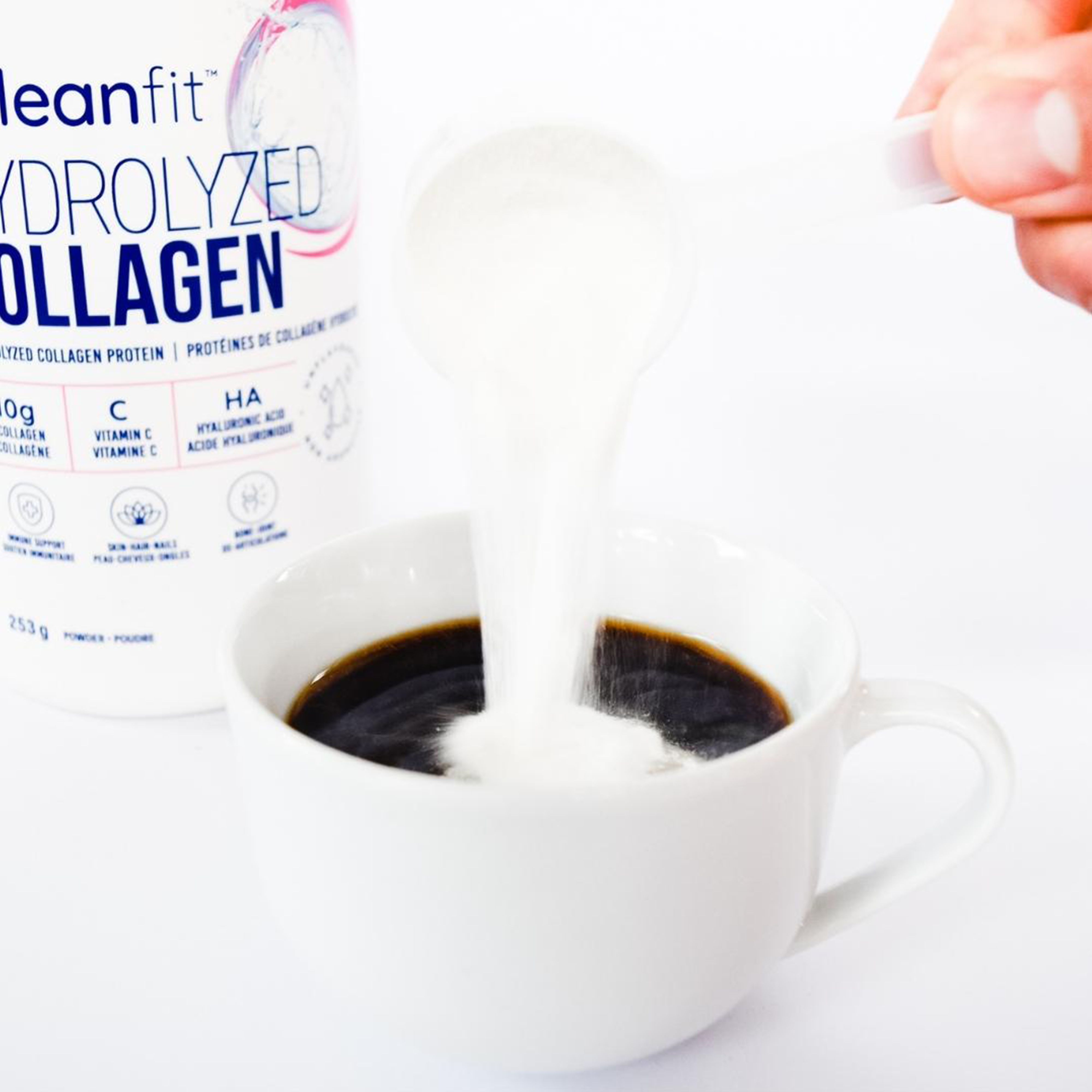 Pouring LEANFIT Hydrolyzed Collagen into hot coffee — unflavoured powder mixes easily