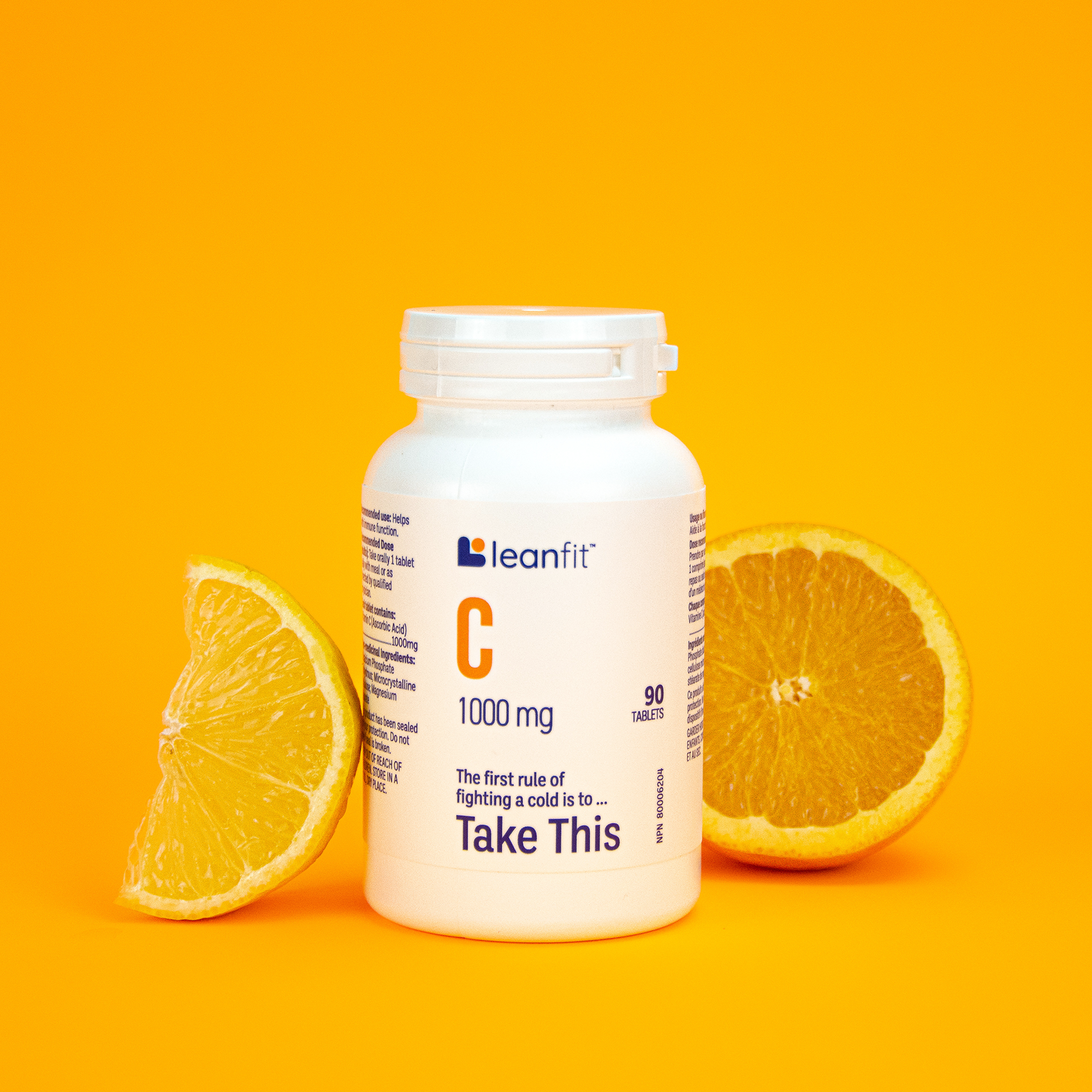 LEANFIT Vitamin C bottle with fresh orange slice on yellow background
